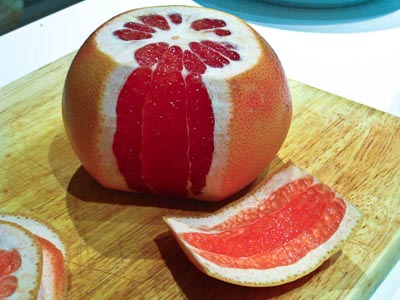 cutting skin from grapefruit
